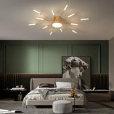 Modern bedroom with a ceiling light fixture, bed, and artwork.